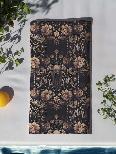 Set of four navy blue dining napkins featuring golden scarab beetles and botanical illustrations in a symmetrical pattern, sized 18x18 inches.